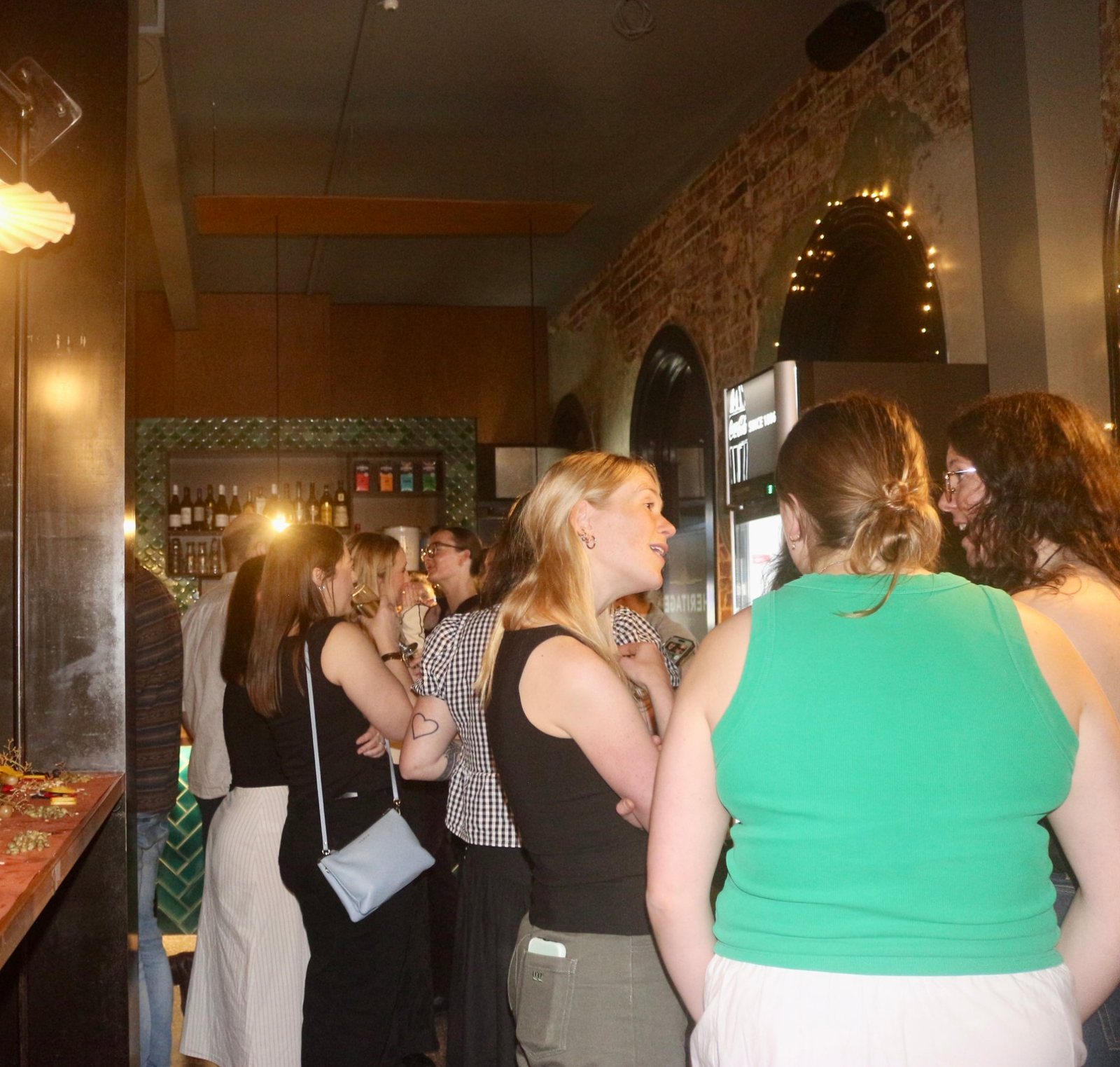 Guests mingling by the bar at an after-work function