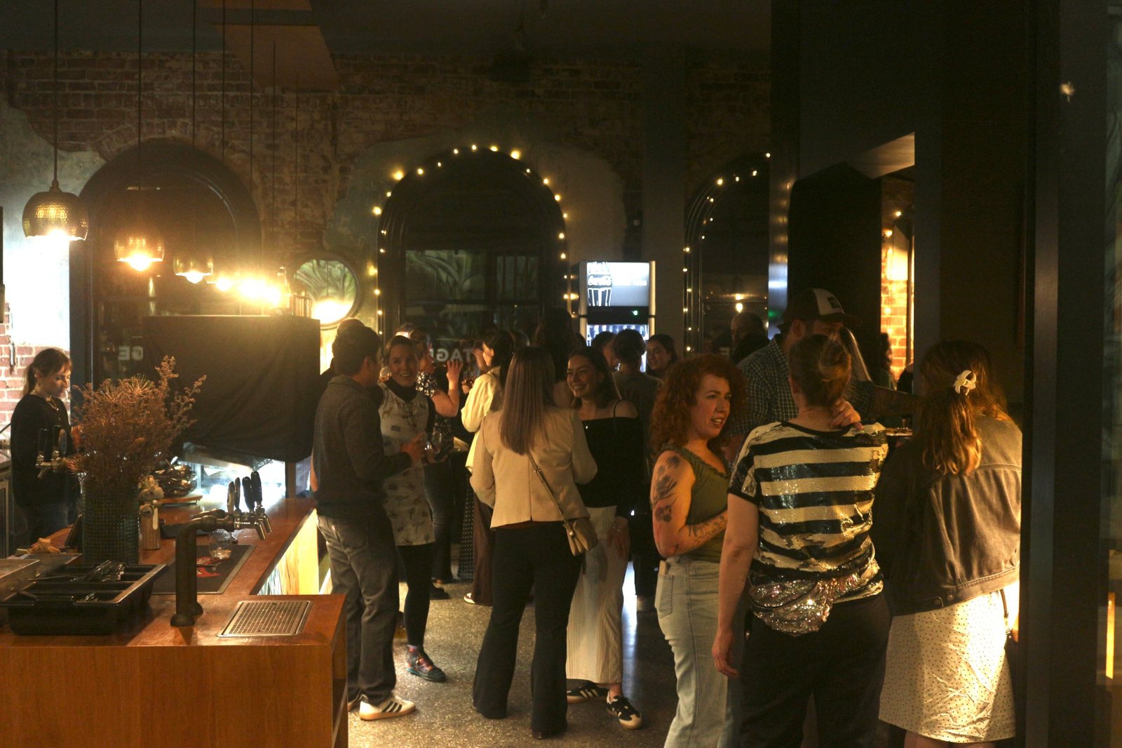 A full room under the fairy lights at an evening function