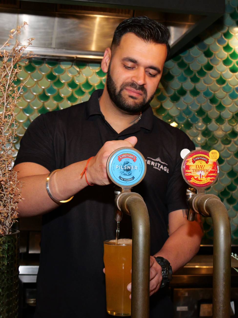 One of the team pouring an Emerson's from the tap