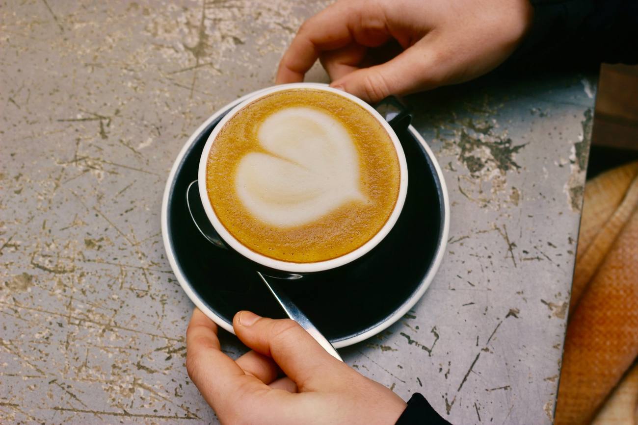 Hands around a flat white