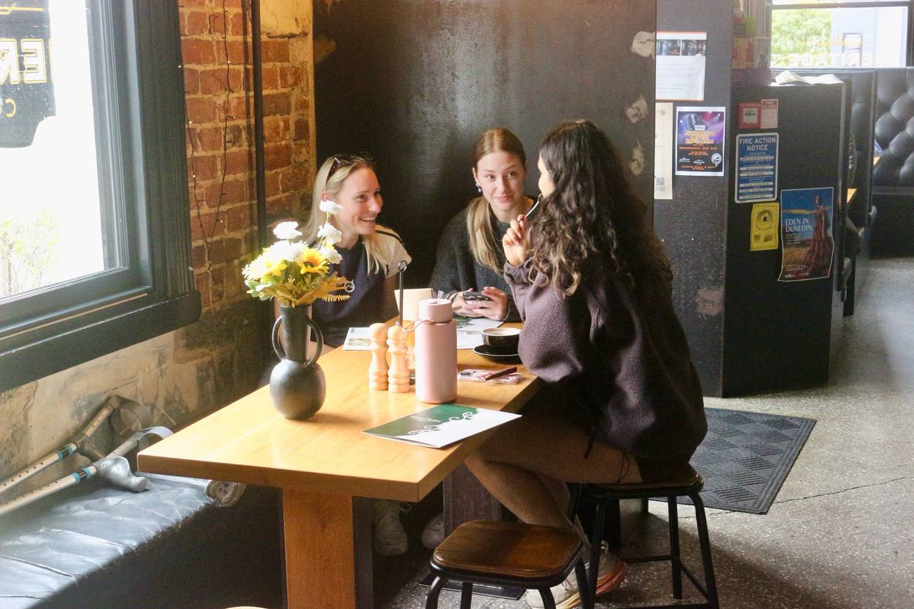 Friends catching up at a table by the window